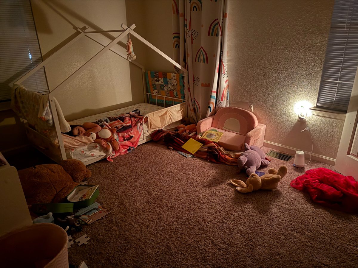 Lucy's nursery — books scattered, nightlight on, sound asleep